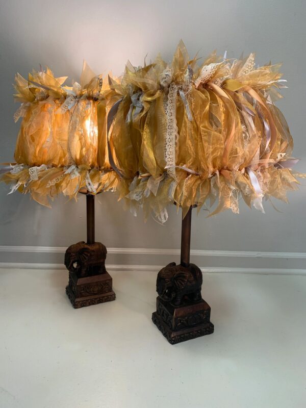 A pair of lamps with a brown base and a yellow shade.